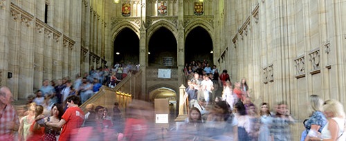 A crowd of people walking through the entrance hall of the Wills Memorial Building